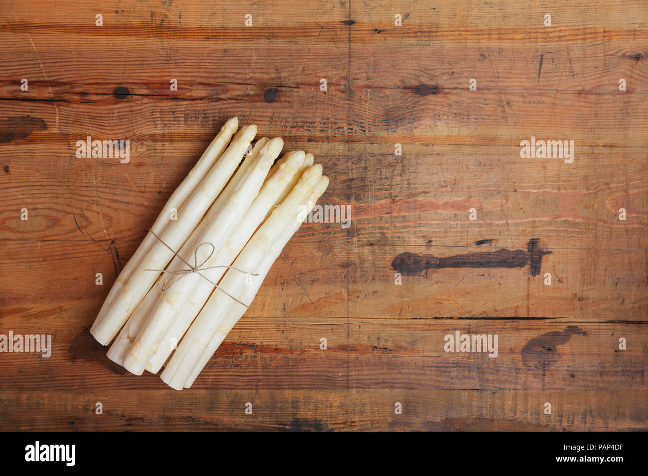 Bunch of white asparagus on wood, copy space Stock Photo