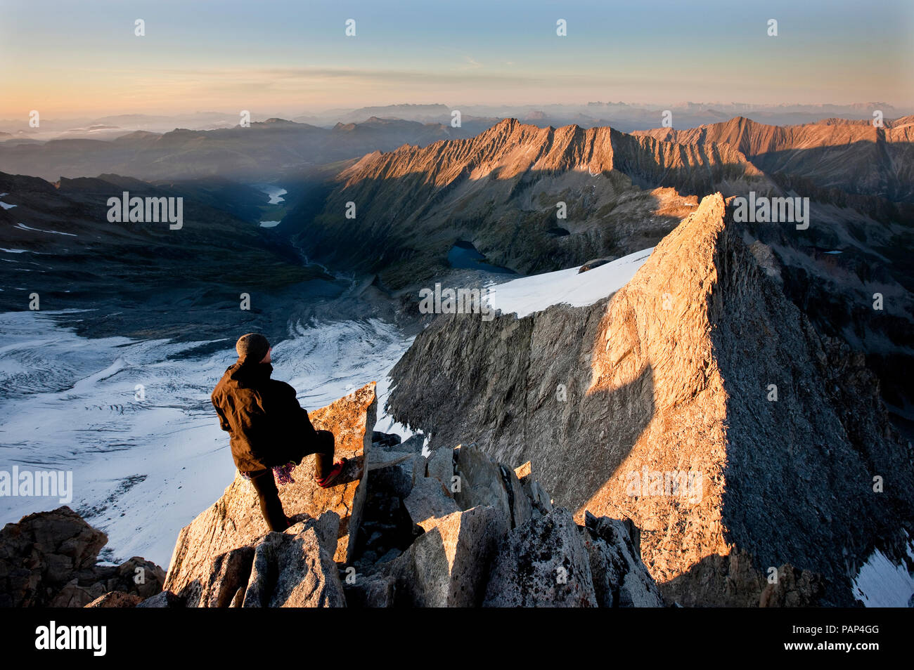 Austria, Tyrol, Zillertal Alps, View from Reichenspitze, climber at glaciated mountains at sunrise, Wildgerlostal, High Tauern National Park Stock Photo