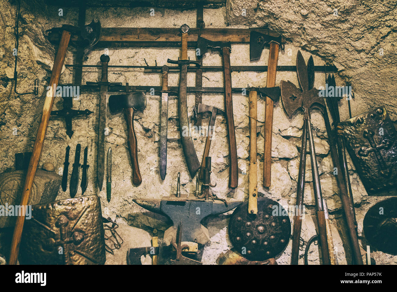 Medieval Knight weapons on a stone wall. Cool background. Stock Photo