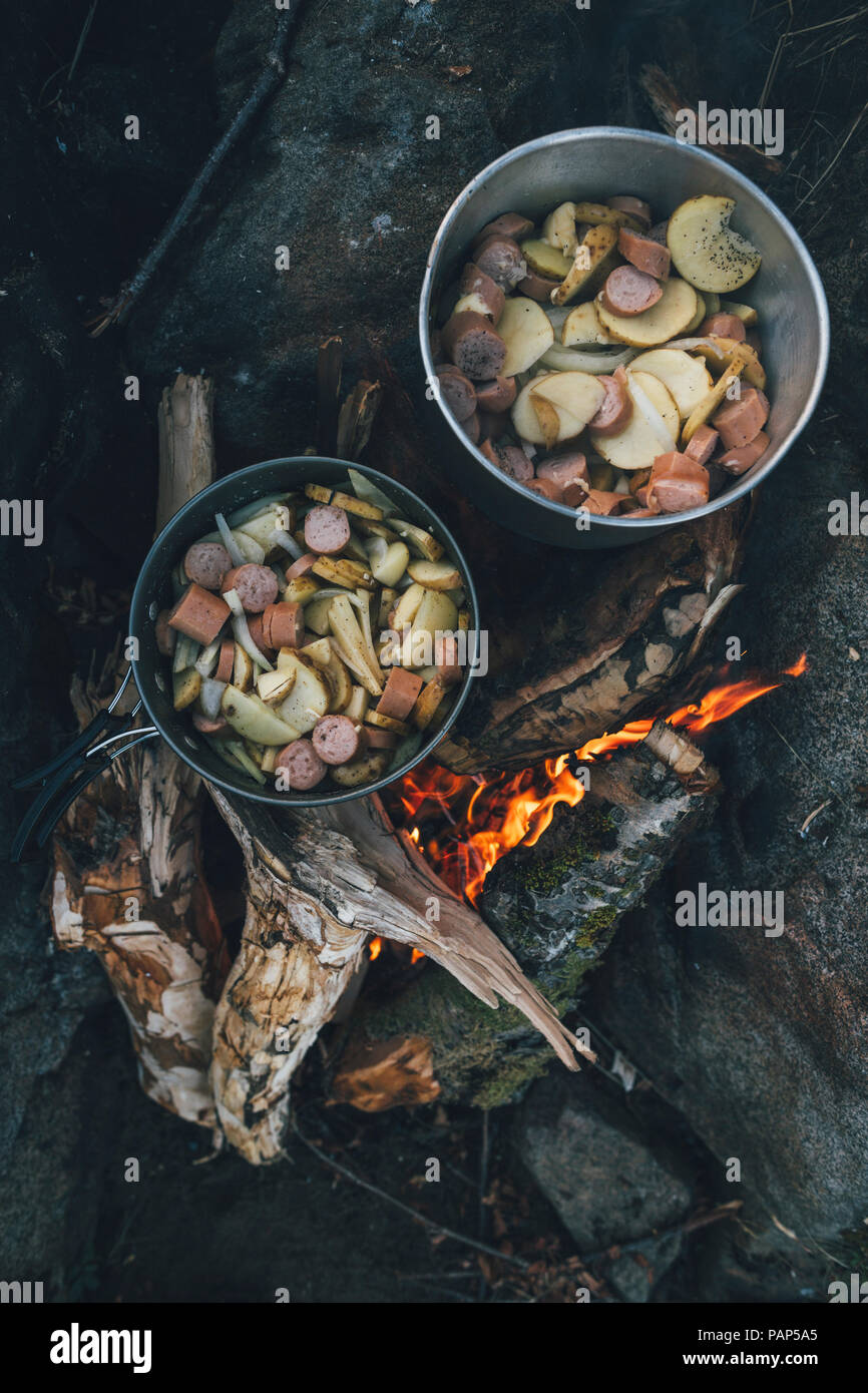 Norway, Lofoten, Moskenesoy, Food cooking on camp fire Stock Photo