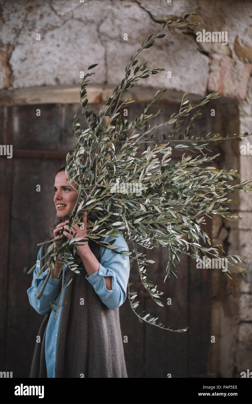 Woman carrying twigs Stock Photo
