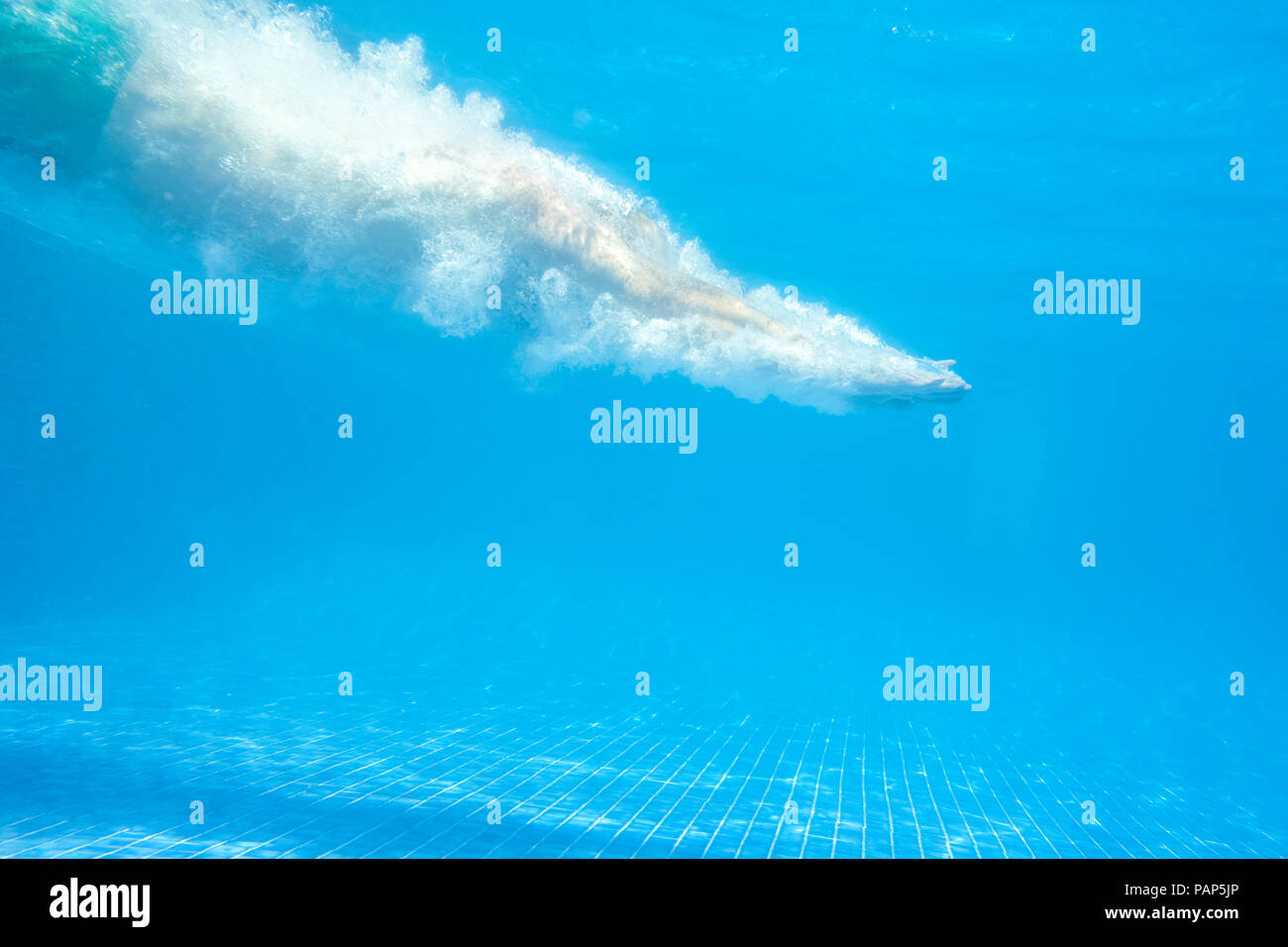 Man jumping into swimming pool Stock Photo