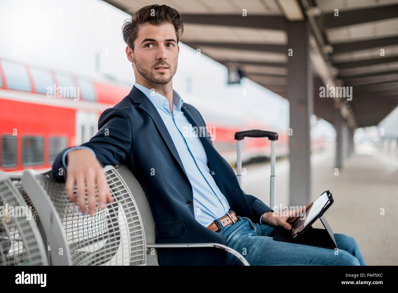 Businessman at the station using tablet Stock Photo