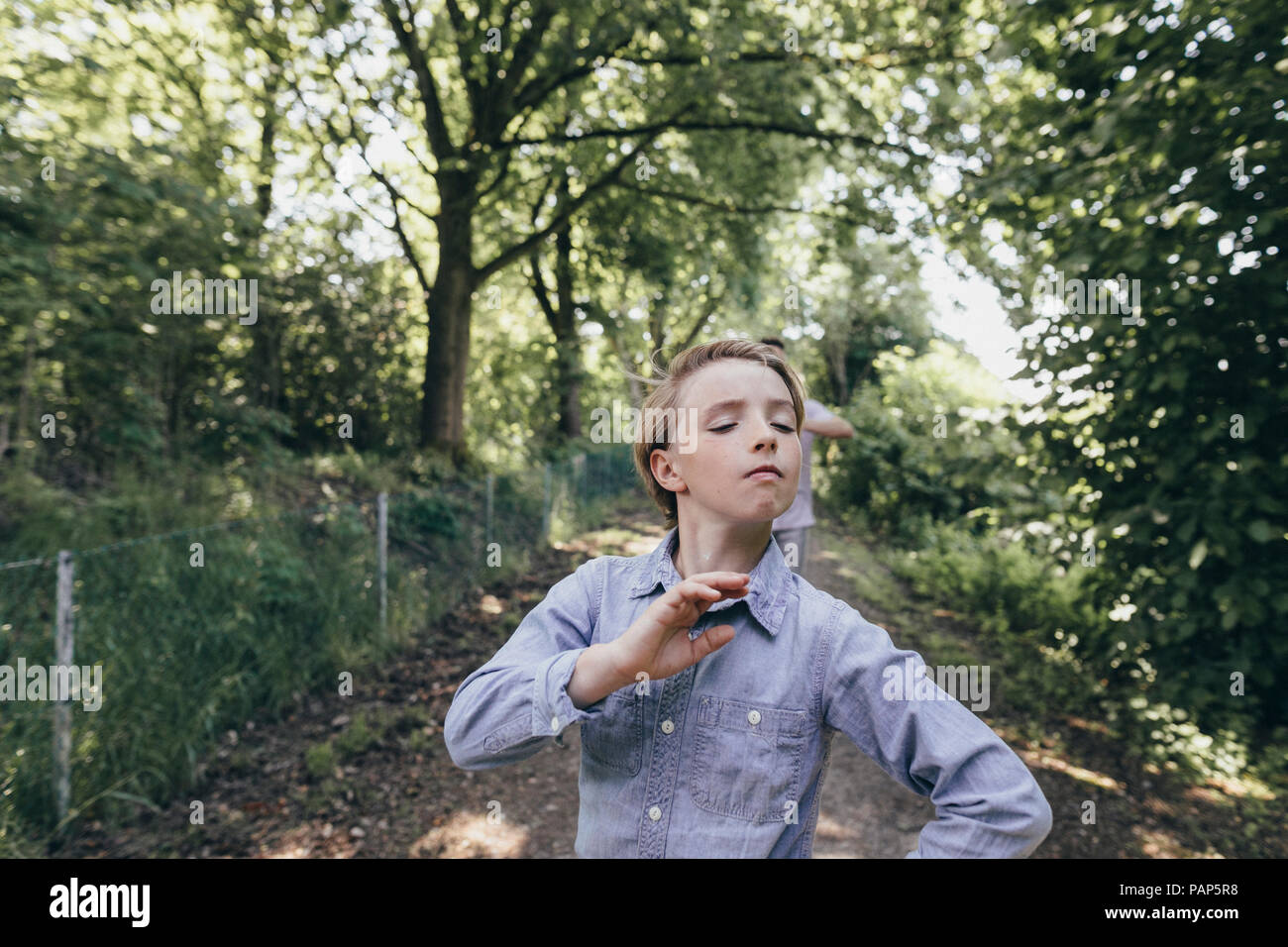 Boy posing on forest path Stock Photo