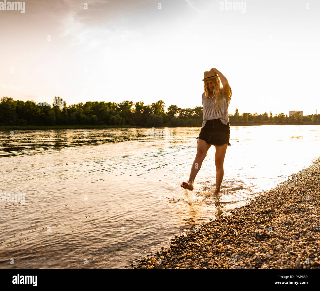 Young woman walking barefoot riverside hi-res stock photography and ...
