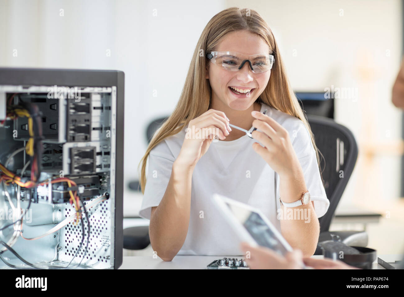 Happy students assembling computer in class Stock Photo