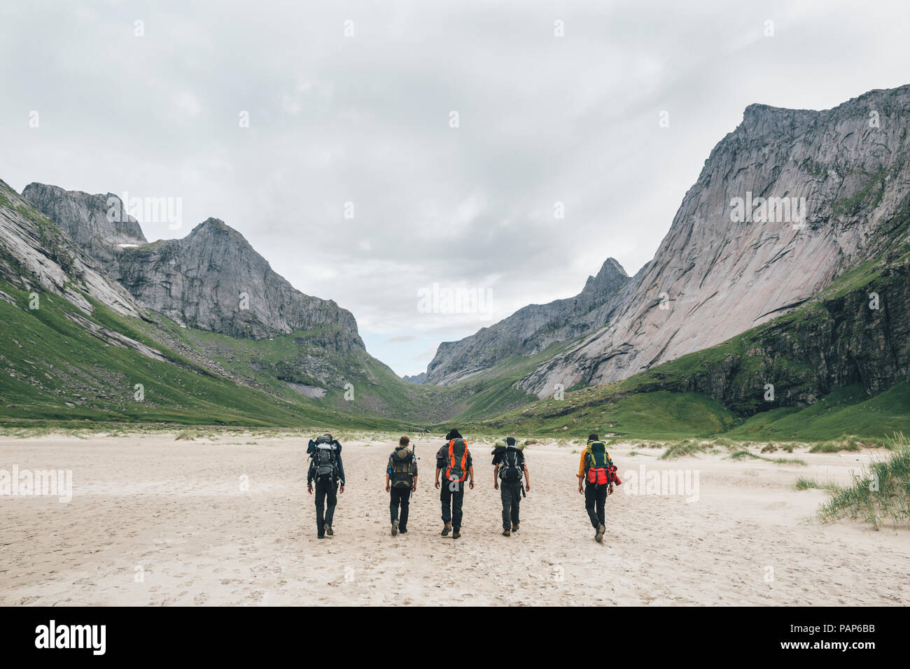 Norway, Lofoten, Moskenesoy, Young men hiking to Horseid Beach Stock Photo