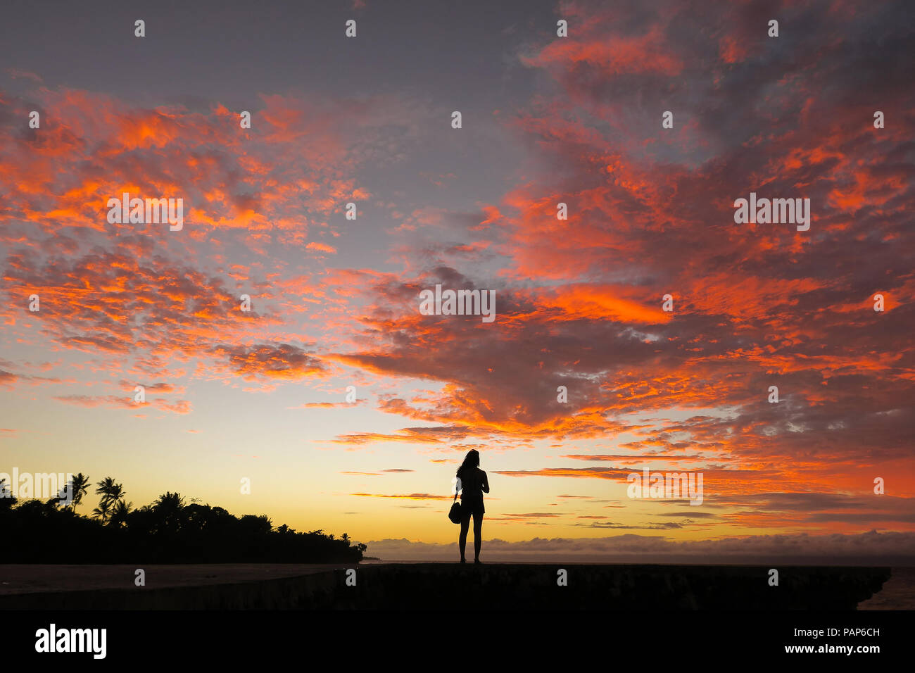 Island Tourist Girl Silhouette With Stunning Pink Sunset Clouds - Bohol, Philippines Stock Photo