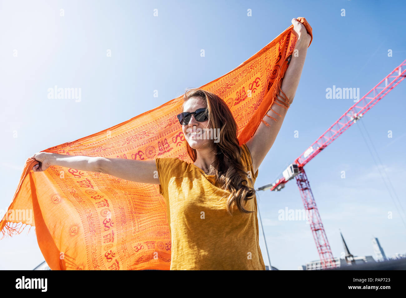 Portrait of smiling woman with sunglasses and cloth Stock Photo