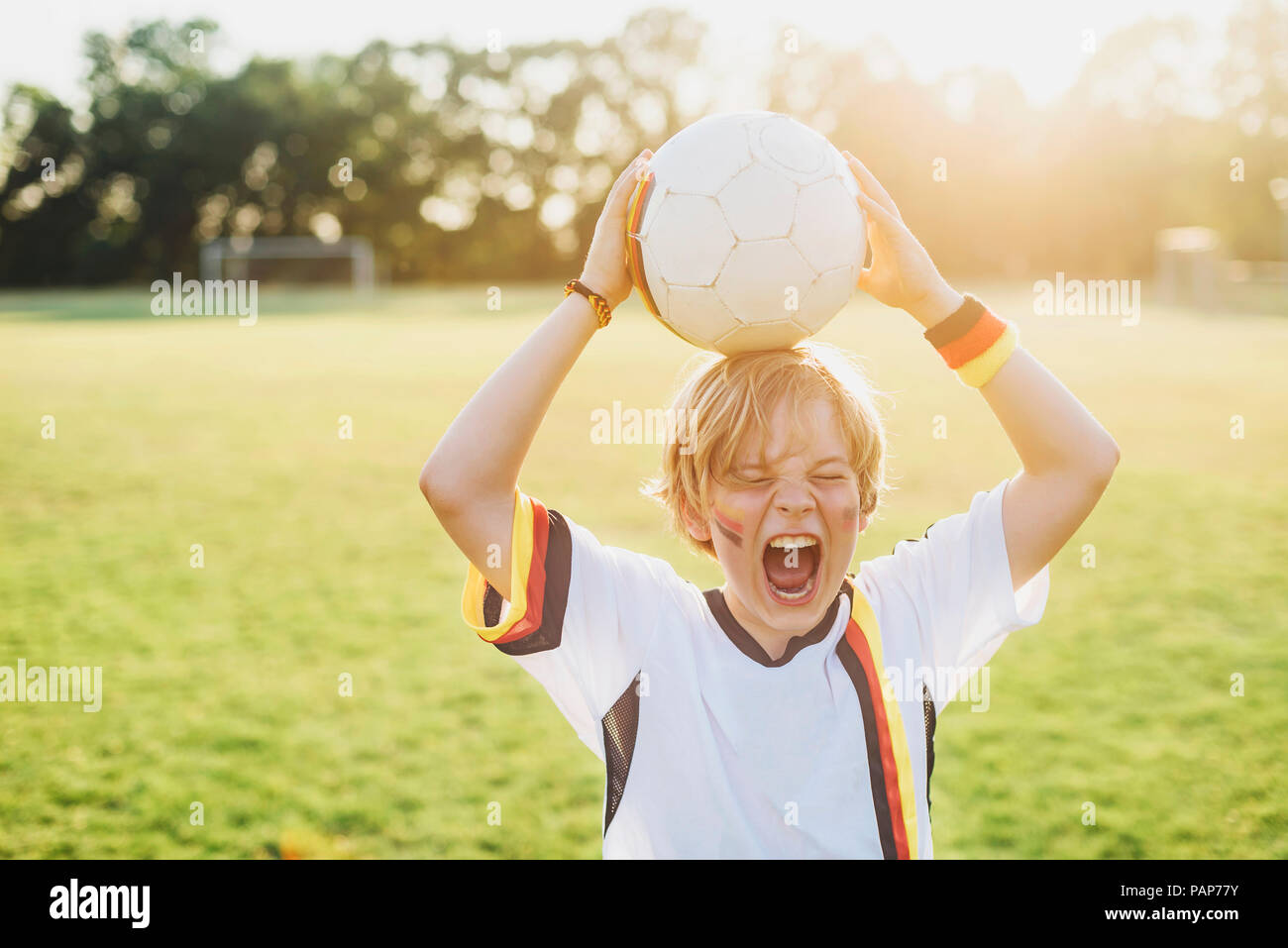 Boy wearing German soccer shirt screaming for joy Stock Photo