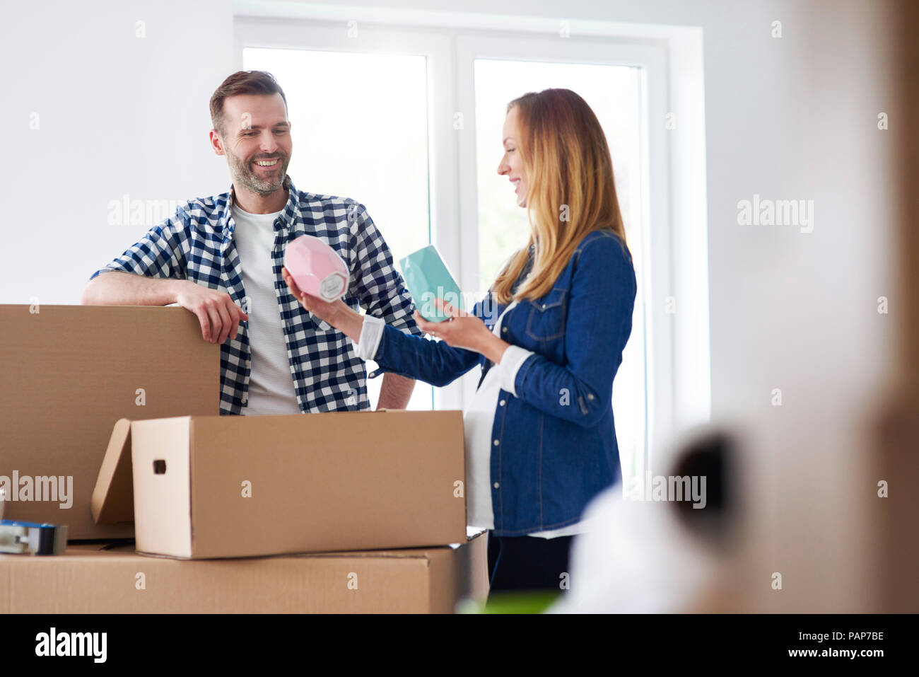 Couple moving into new flat packing cardboard boxes Stock Photo - Alamy