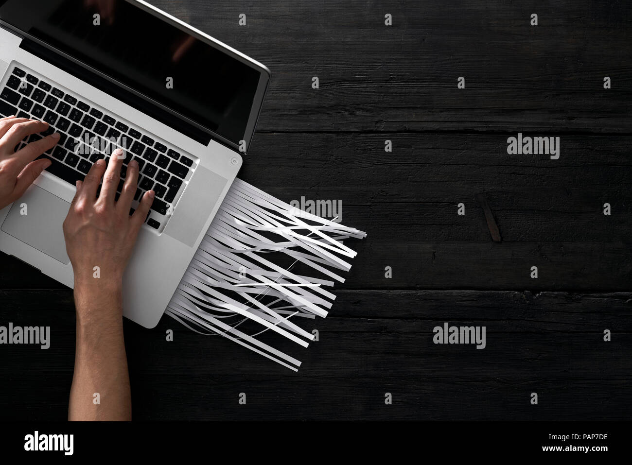 Paperless office, person using laptop on black background Stock Photo