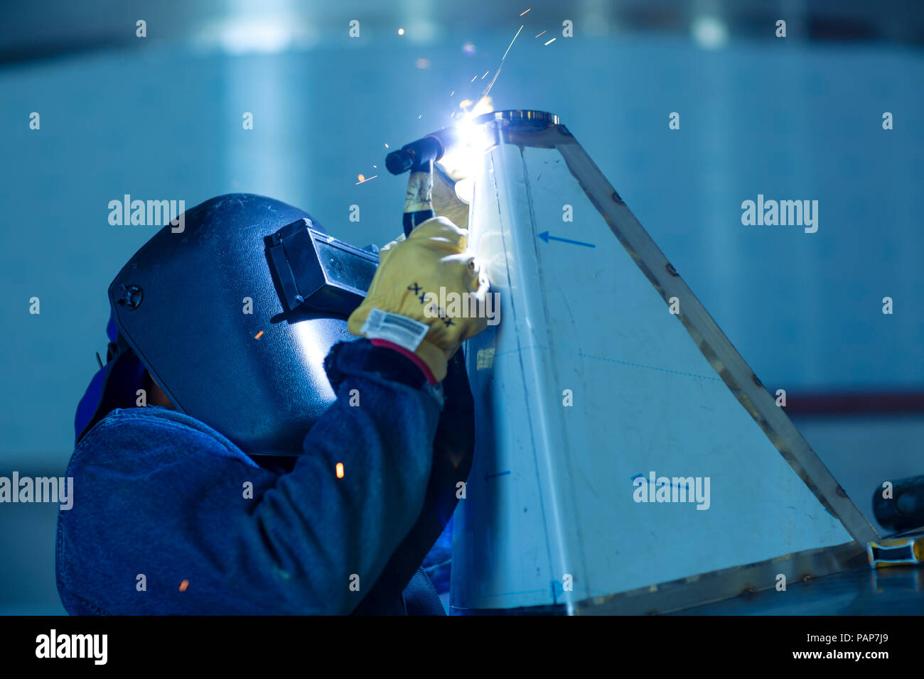 Welder in industrial plant welding tanks Stock Photo