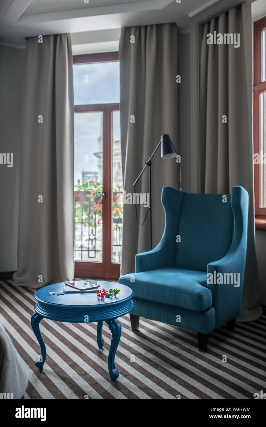 Bright Hotel Room With Light Walls And A Striped Floor There Is A