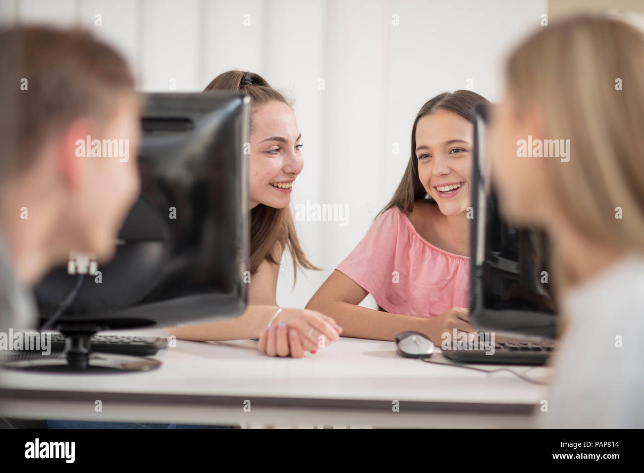 Students talking in computer class Stock Photo