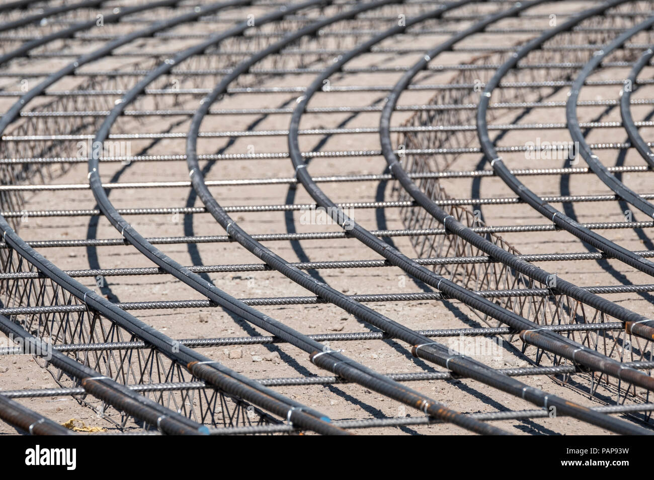 Steel Rebars for reinforced concrete. Closeup of Steel rebars. Geometric alignment of Rebars on construction site Stock Photo