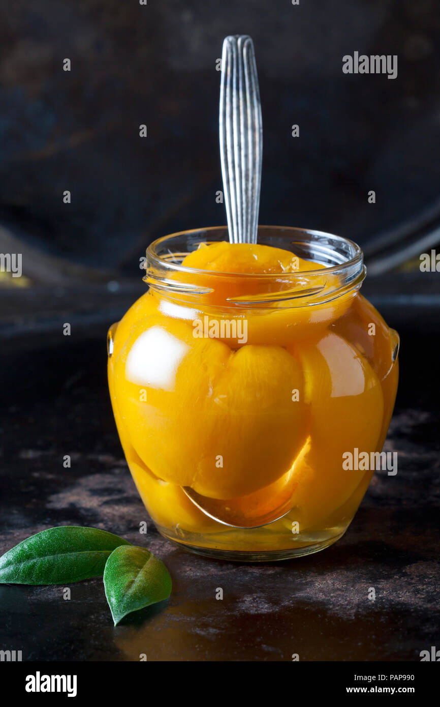 Glass of preserved peach halves Stock Photo