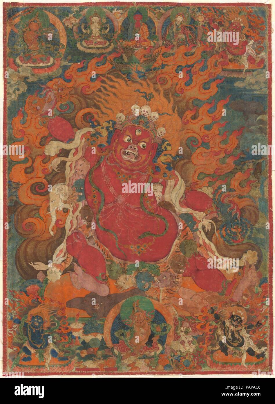 Guru Dragpo. Culture: Tibet. Dimensions: Image: 24 in. × 17 1/2 in. (61 × 44.5 cm)  Framed: 33 1/16 × 25 13/16 in. (84 × 65.5 cm). Date: 18th century.  Guru Dragpo, a fierce emanation of the guru-saint Padmasambhava, stands astride a flaming aureole holding a ritual tool, the vajra, and a black scorpion. The skin of a tiger is drawn around his waist while the flayed skin of an elephant is draped over his shoulders. He wears a crown adorned with skulls and a garland of severed heads. In this wrathful meditational form, Guru Dragpo was an important protector deity of the Nyingma School of Tibeta Stock Photo