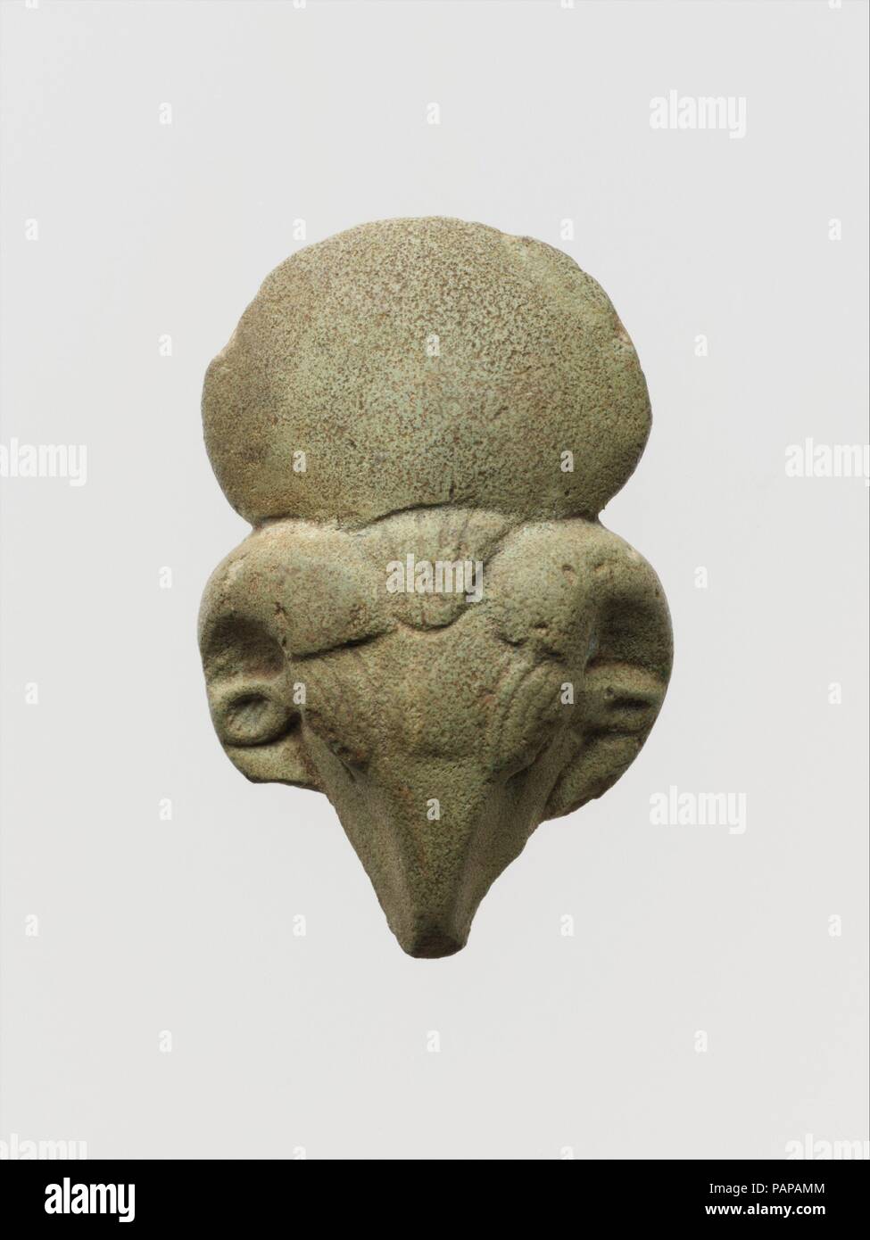 Faience ram's head amulet. Culture: Egyptian. Dimensions: H.: 1 3/4 in. (4.4 cm). Date: 712-664 B.C..  Amulets representing animals were attributed to a deity: a hawk for Ra, the Sun God, a lion for Sakhmi, the War Goddess, a ram for Khnum and a cat for Bast. Museum: Metropolitan Museum of Art, New York, USA. Stock Photo