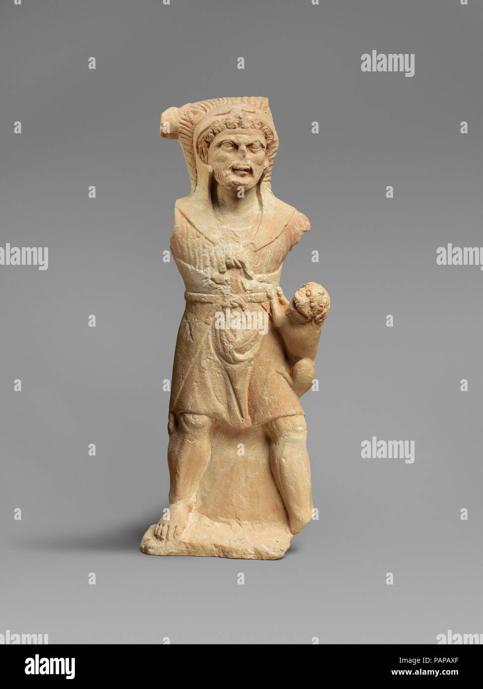 Limestone statue of Herakles. Culture: Cypriot. Dimensions: Overall: 21 3/8 x 8 x 2 3/4 in. (54.3 x 20.3 x 7 cm). Date: 2nd half of the 4th century B.C..  In the late sixth century B.C. a local Cypriot god was assimilated with the powerful animal-slaying Greek hero, Herakles. On Cyprus he is shown bearded or beardless, wearing a lion's skin and a short tunic and holding a miniature lion in his hand. Herakles was the male divinity most often represented in Cypriot sanctuaries. In the Classical period, King Evagoras of Salamis placed images of Herakles as a Panhellenic hero on his coinage. At th Stock Photo