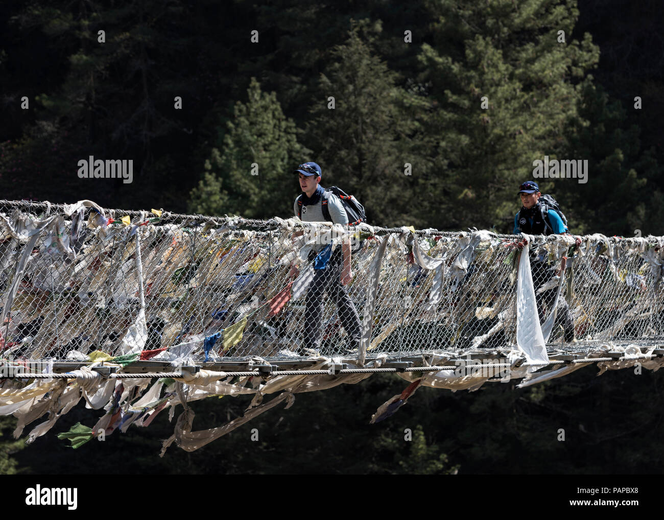 Nepal, Solo Khumbu, Everest, Sagamartha National Park, Two people crossing suspension bridge Stock Photo