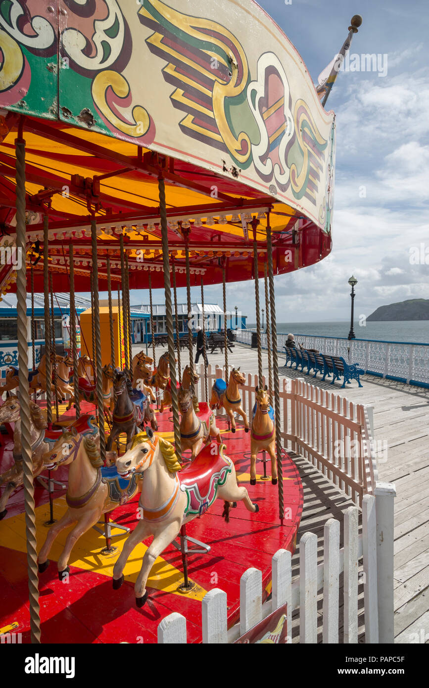 Colourful old carousel at the ed of the pier at Llandudno, North Wales, UK. Stock Photo