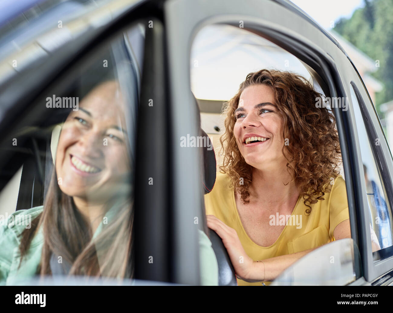 Two happy women in electric bubble car Stock Photo