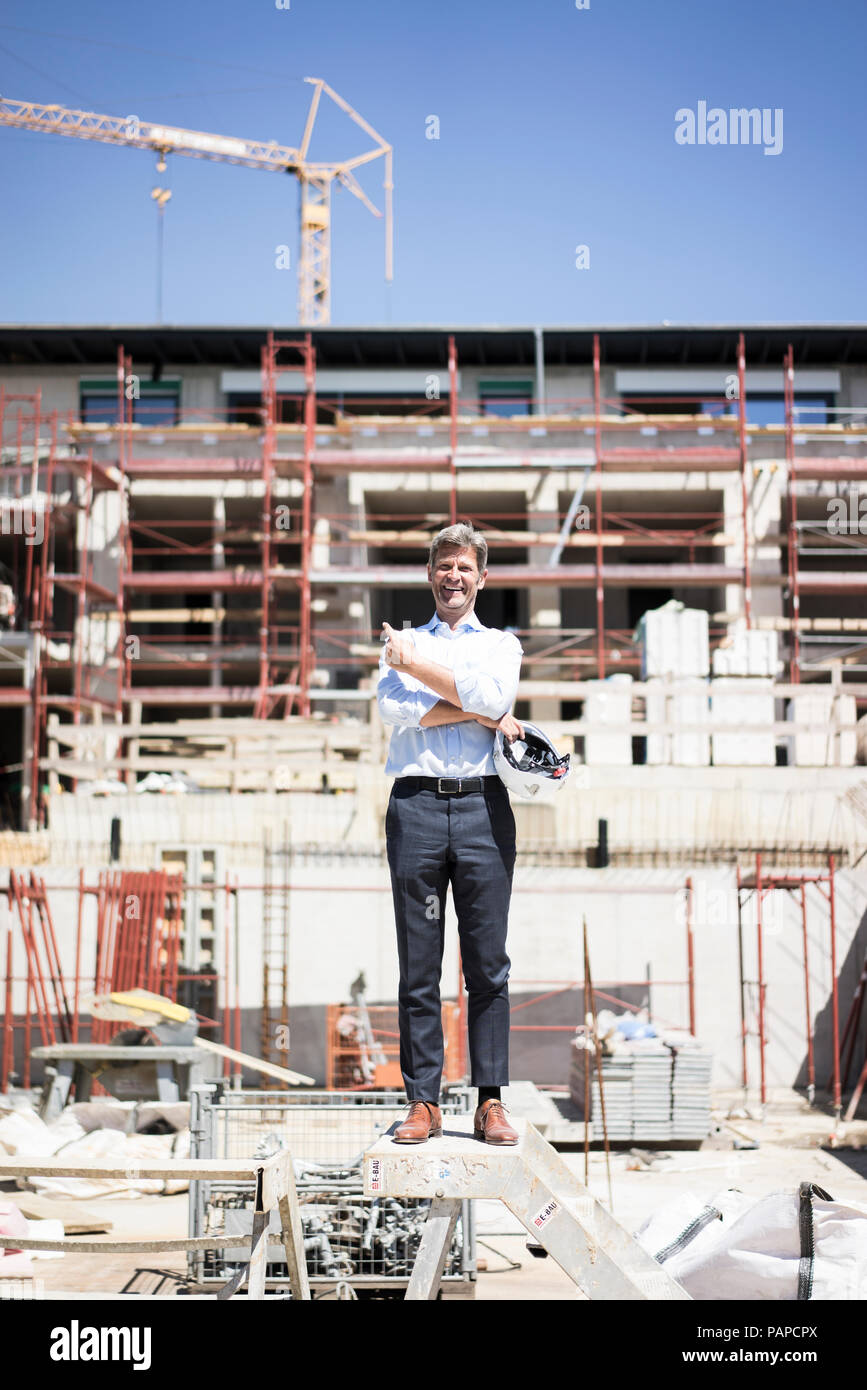 Portrait of happy man standing on construction site Stock Photo - Alamy