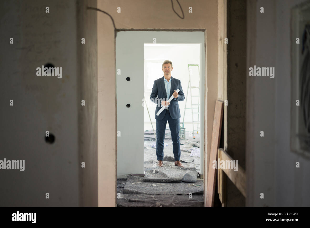 Architect standing in building under construction Stock Photo