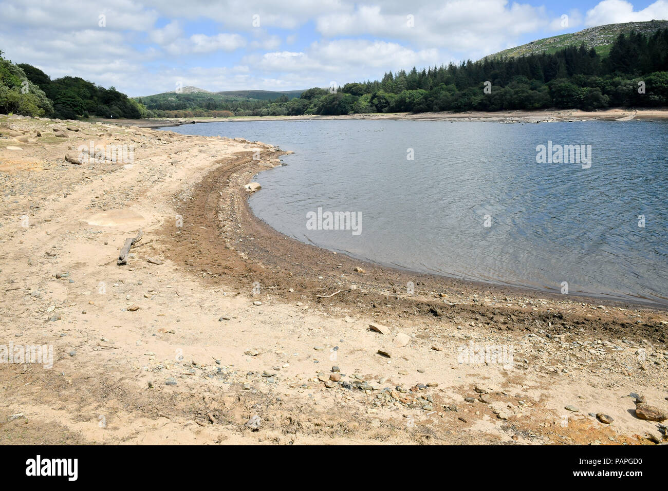 Water levels fall low at Burrator reservoir, Dartmoor, Devon, during the driest start to a summer since modern records began in 1961, as the region prepares to welcome millions of holidaymakers over the school summer break and South West Water is asking everyone to use water wisely. Stock Photo