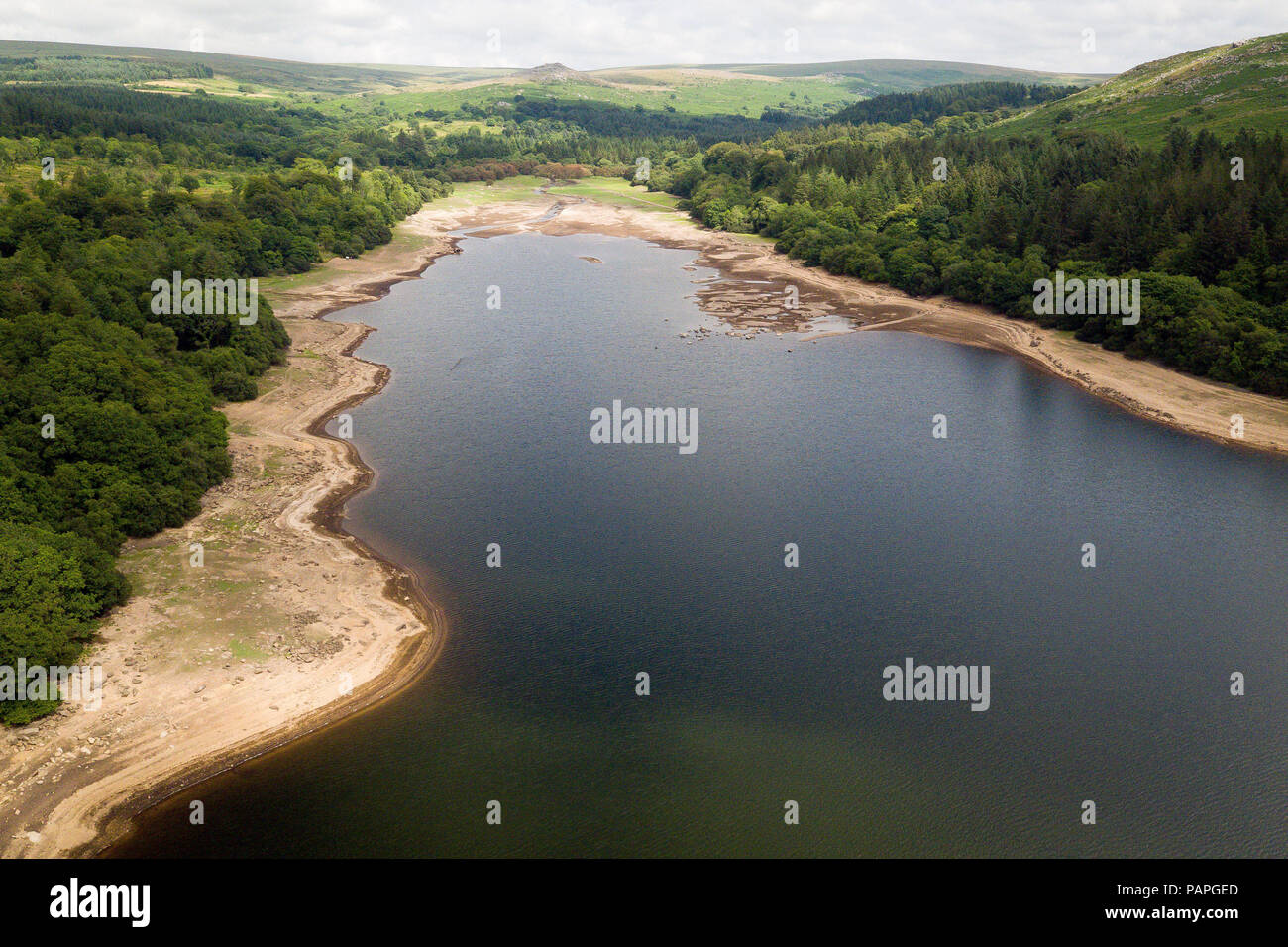 Water levels fall low at Burrator reservoir, Dartmoor, Devon, during the driest start to a summer since modern records began in 1961, as the region prepares to welcome millions of holidaymakers over the school summer break and South West Water is asking everyone to use water wisely. Stock Photo