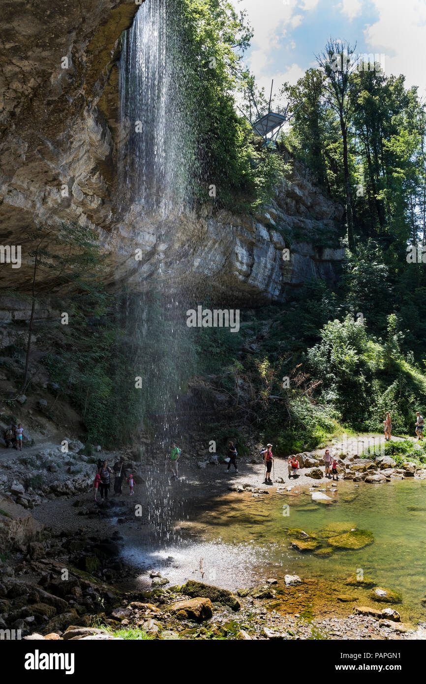 Visitors Enjoying the 35m Saut Girard Waterfall on a Hot Summer Day, Cascades du Herrison, Jura, France. Stock Photo
