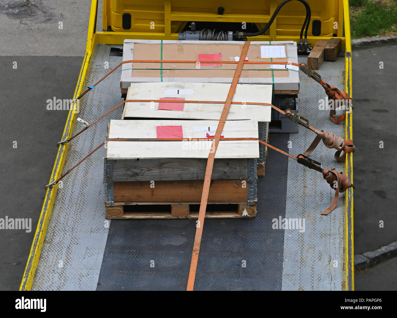 Cargo crates tied at flatbed truck Stock Photo - Alamy