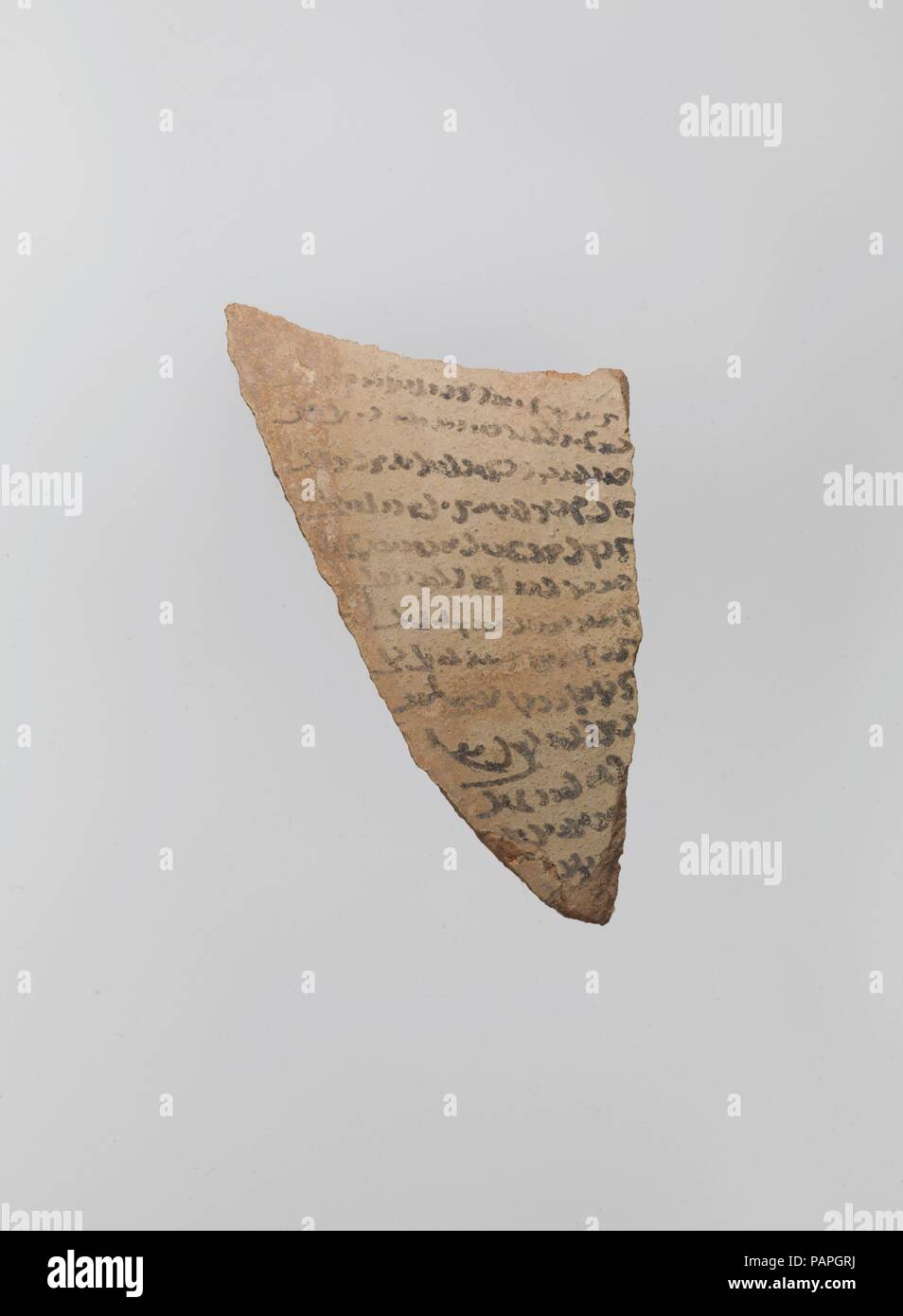 Magic Bowl and an Ostrakon. Dimensions: H. 4 1/8 in. (10.4 cm)  W. 2 5/16 in.(5.8 cm)  D. 1/4 in. (0.7 cm). Date: 9th-10th century.  This fragment appears to be written in a local variant of Pahlavi, the ancient script of the Persian language, which remained in use, beside Arabic, at least until the 10th century, especially in Zoroastrian circles. This fragment seems to provide evidence of Nishapur's non-Muslim population. Museum: Metropolitan Museum of Art, New York, USA. Stock Photo