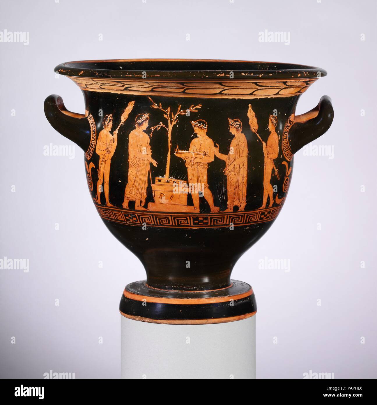 Terracotta bell-krater (bowl for mixing wine and water). Culture: Greek, Attic. Dimensions: H. 12 5/8 in. (32.1 cm)  diameter  13 3/8 in. (33.9 cm)  width with handles  14 5/16 in. (36.3 cm). Date: late 5th century B.C..  Obverse, sacrifice at an altar  Reverse,  three youths  The altar is stacked with wood to burn the meat offering, prepared on skewers and being carried by attendants on either side. The other two attendants carry a tray and a basket. The recipient of the sacrifice is not identified. The laurel tree behind the altar might indicate Apollo. Museum: Metropolitan Museum of Art, Ne Stock Photo