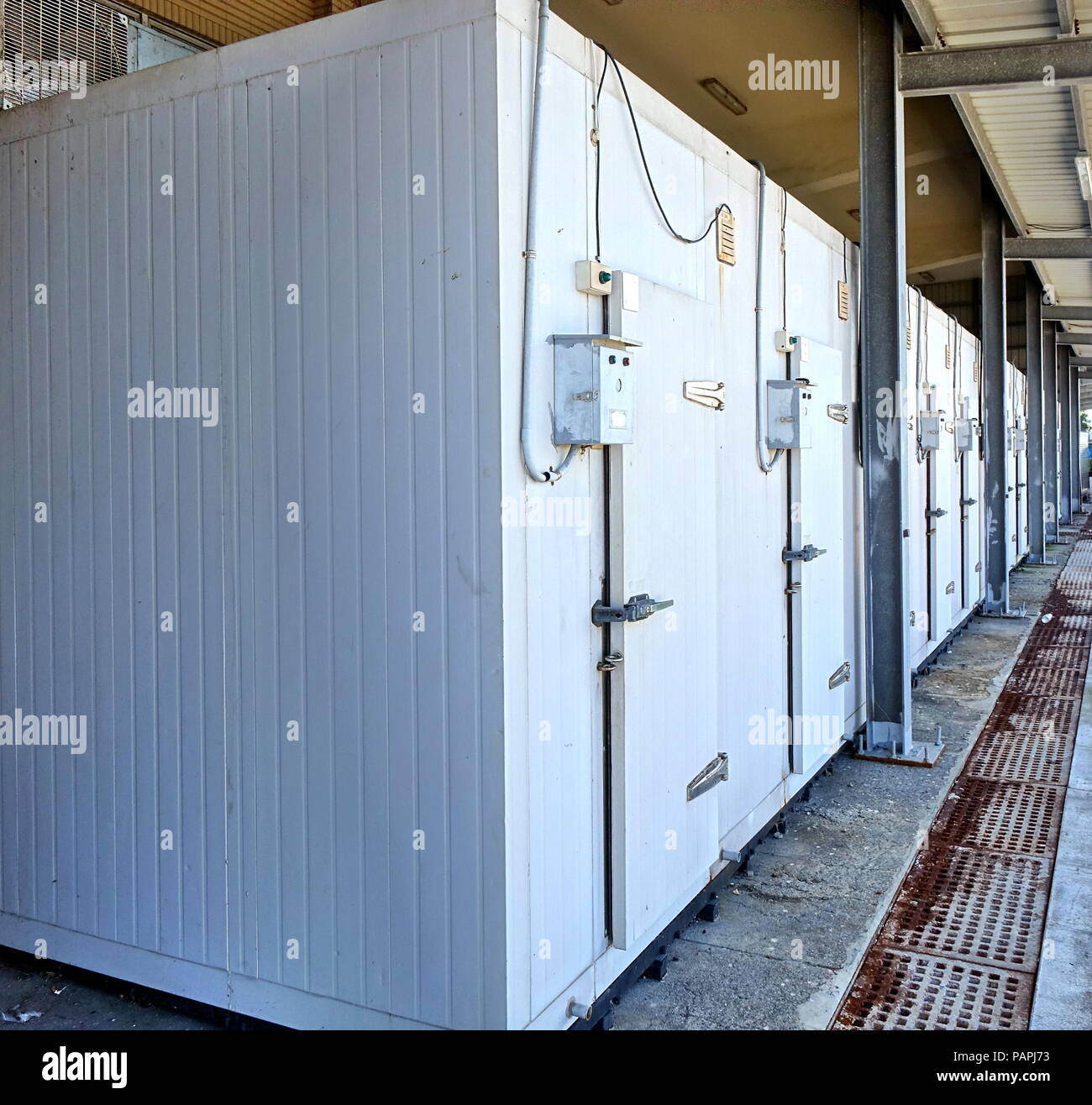A row of walk-in refrigerators and freezer at a commercial cold storage facility Stock Photo