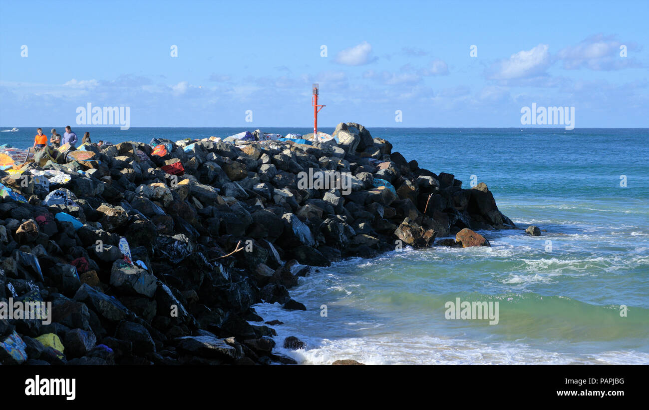 People walking enjoying day out at breakwater or Breakwall coastal town of Port Macquarie in New South Wales, Australia Stock Photo