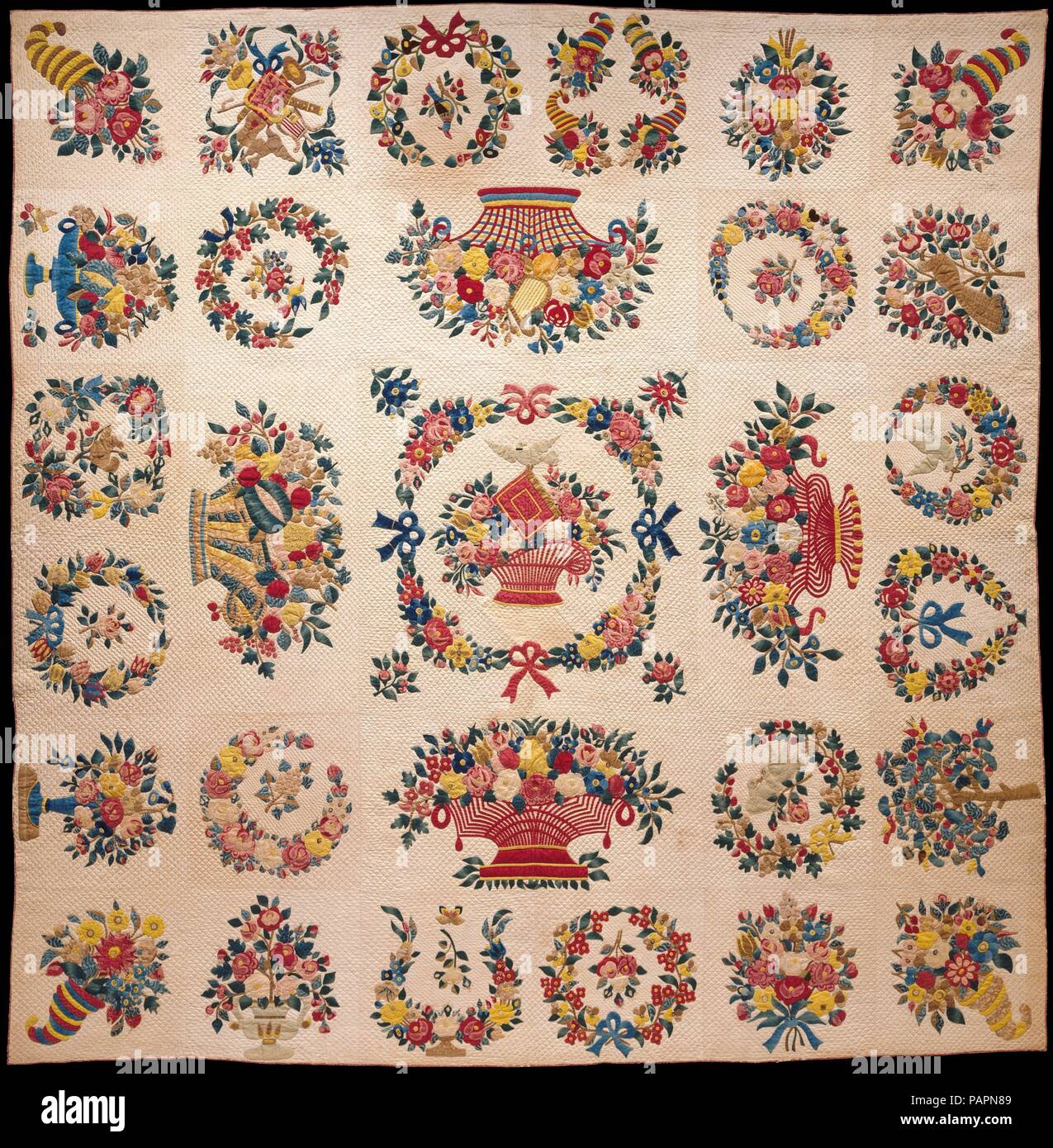Quilt, Presentation pattern. Culture: American. Designer: Designs attributed to Mary Hergenroder Simon (1808-1877). Dimensions: 106 1/4 x 103 3/4 in. (269.9 x 263.5 cm). Date: ca. 1849.  This Baltimore Presentation quilt is appliquéd with vibrant floral wreaths, a delicate basket of fruits and flowers, and assorted birds in multicolored cottons. It is most likely the work of Mary Simon (born 1810), who is thought to have worked as a professional quiltmaker in Baltimore during the 1840s and 1850s. The designs on the quilt are separate bits of brightly colored fabric. Since this quilt was made c Stock Photo