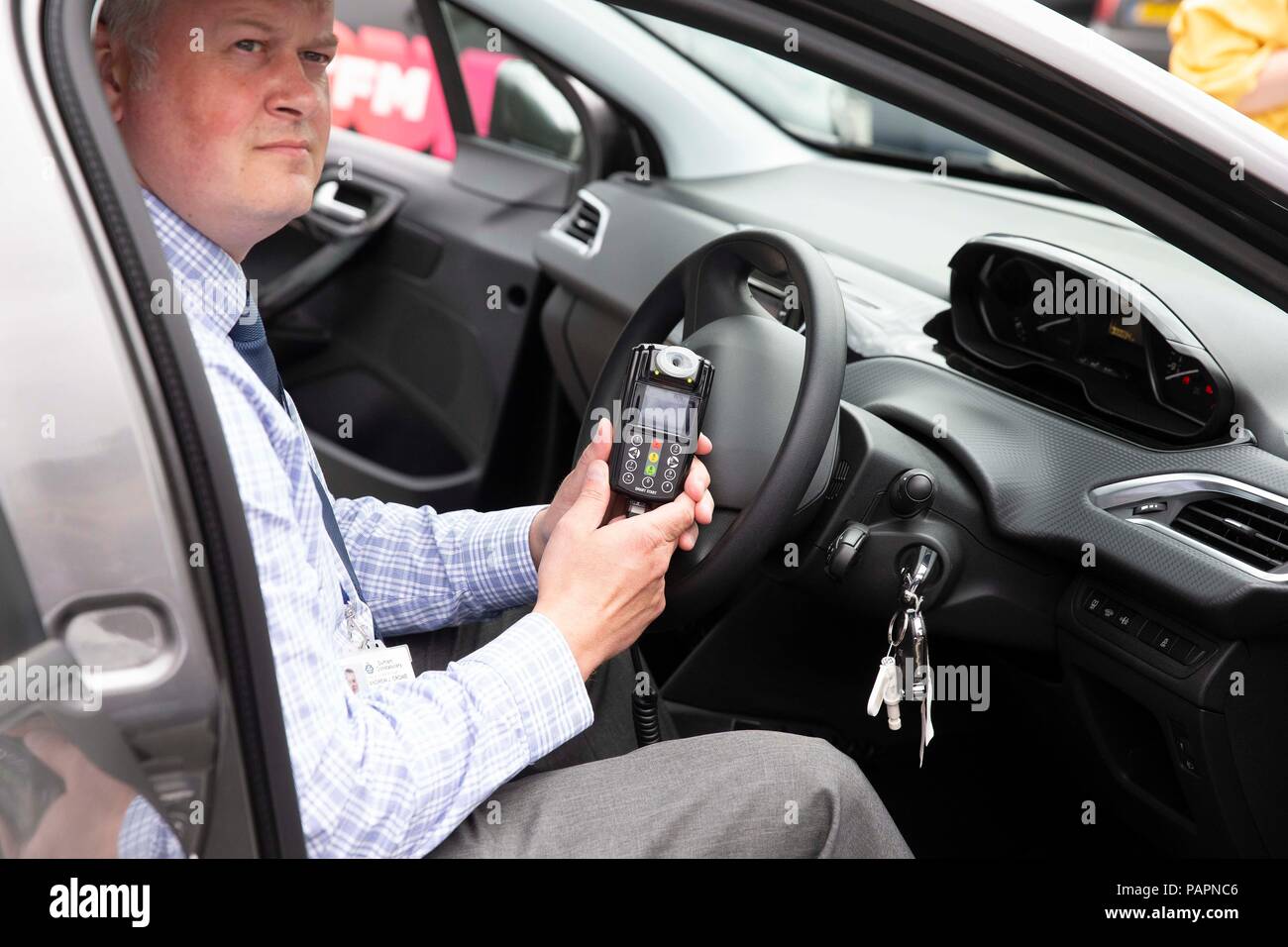 DI Andy Crowe demonstrates the in car alcohol interlock device which stops drink drivers from starting their engine if they are over the legal drink drive limit, at Durham Police headquarters. Stock Photo