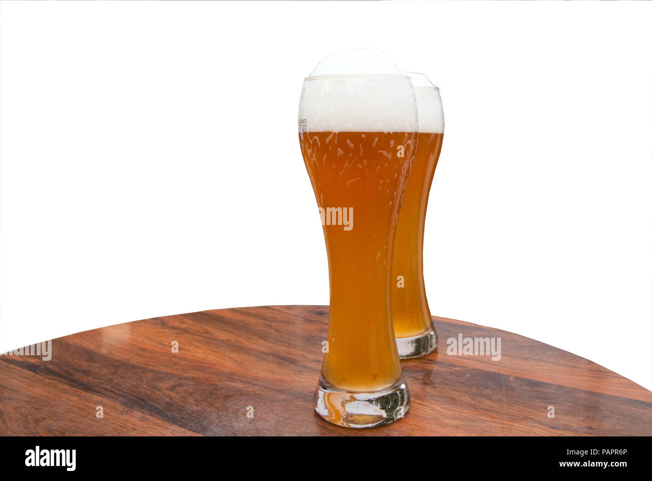 Two large glasses of weiss (white) German beer on a table Stock Photo