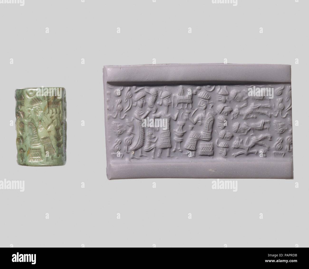 Cylinder seal and modern impression: goddess leading a worshiper to a seated deity; bull god. Culture: Old Assyrian Trading Colony. Dimensions: 0.87 in. (2.21 cm). Date: ca. 20th-19th century B.C..  Although engraved stones had been used as early as the seventh millennium B.C. to stamp impressions in clay, the invention in the fourth millennium B.C. of carved cylinders that could be rolled over clay allowed the development of more complex seal designs. These cylinder seals, first used in Mesopotamia, served as a mark of ownership or identification. Seals were either impressed on lumps of clay  Stock Photo