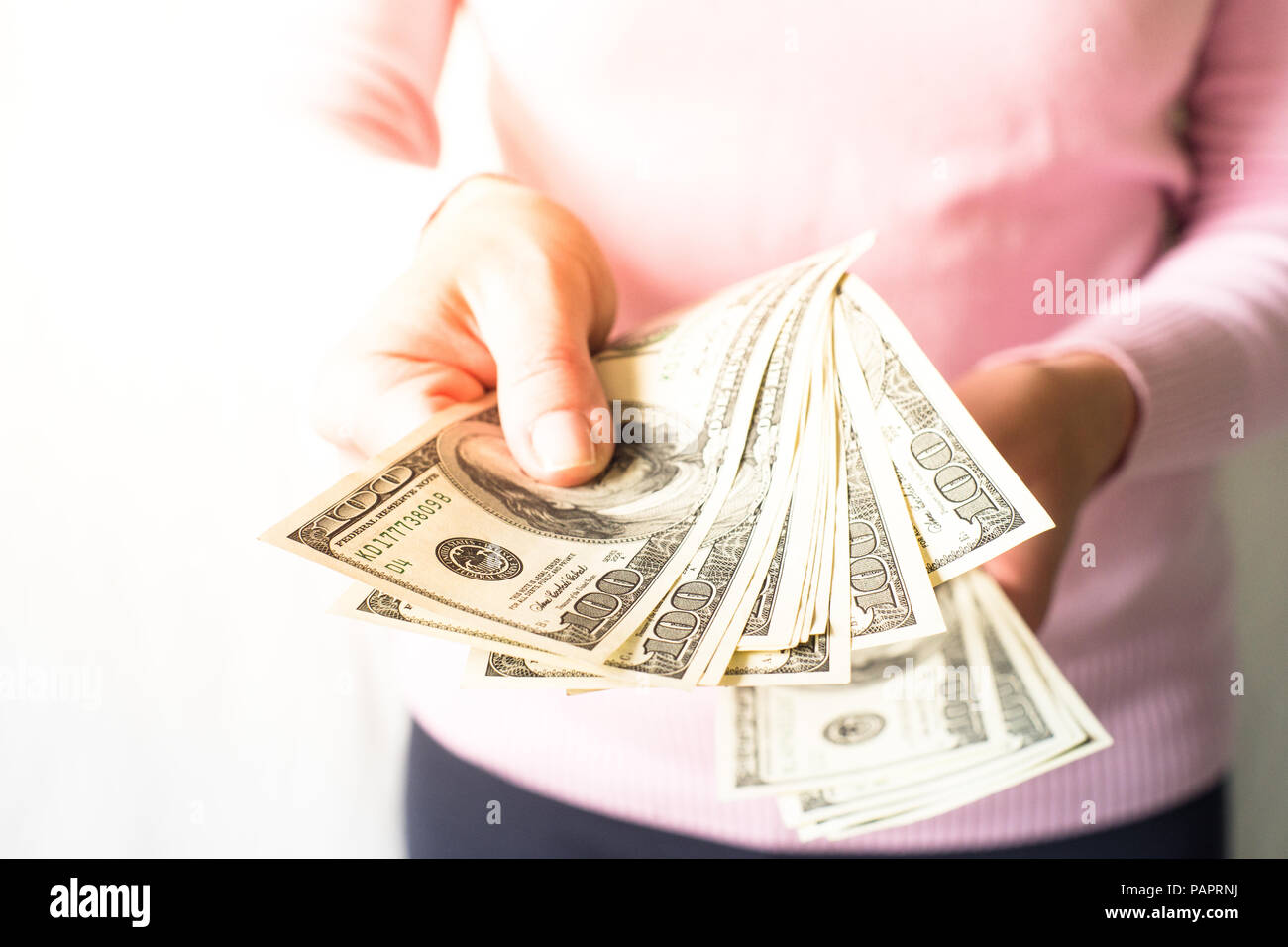 Woman is holding money in her hands. Cash dollar bills. Payment. Stock Photo