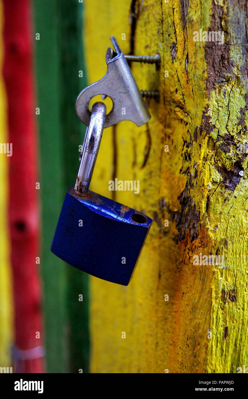 Old blue padlock on rustic wooden door Stock Photo