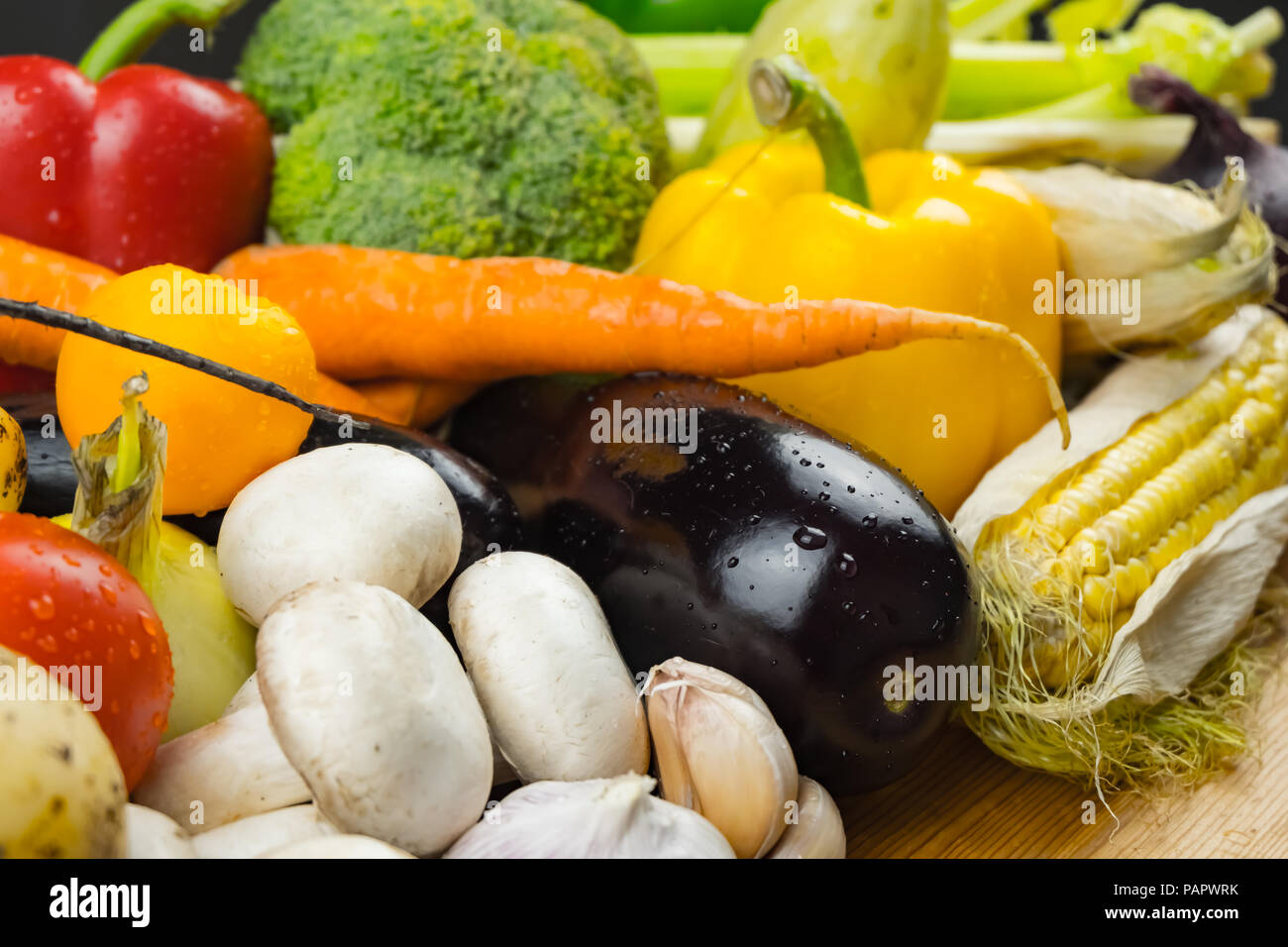 Fresh organic vegetables on rustic wood table, close-up. Rich diversity of locally grown natural vegan food laying on table Stock Photo