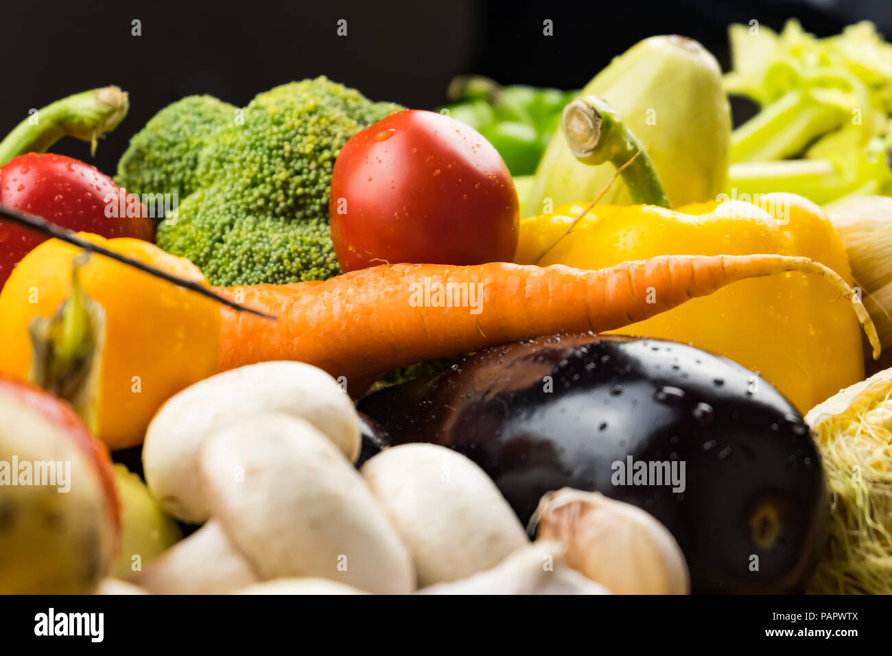 Locally grown bell pepper, corn, carrot, mushrooms and other natural vegan food laying on table. Close-up image of fresh organic vegetables Stock Photo