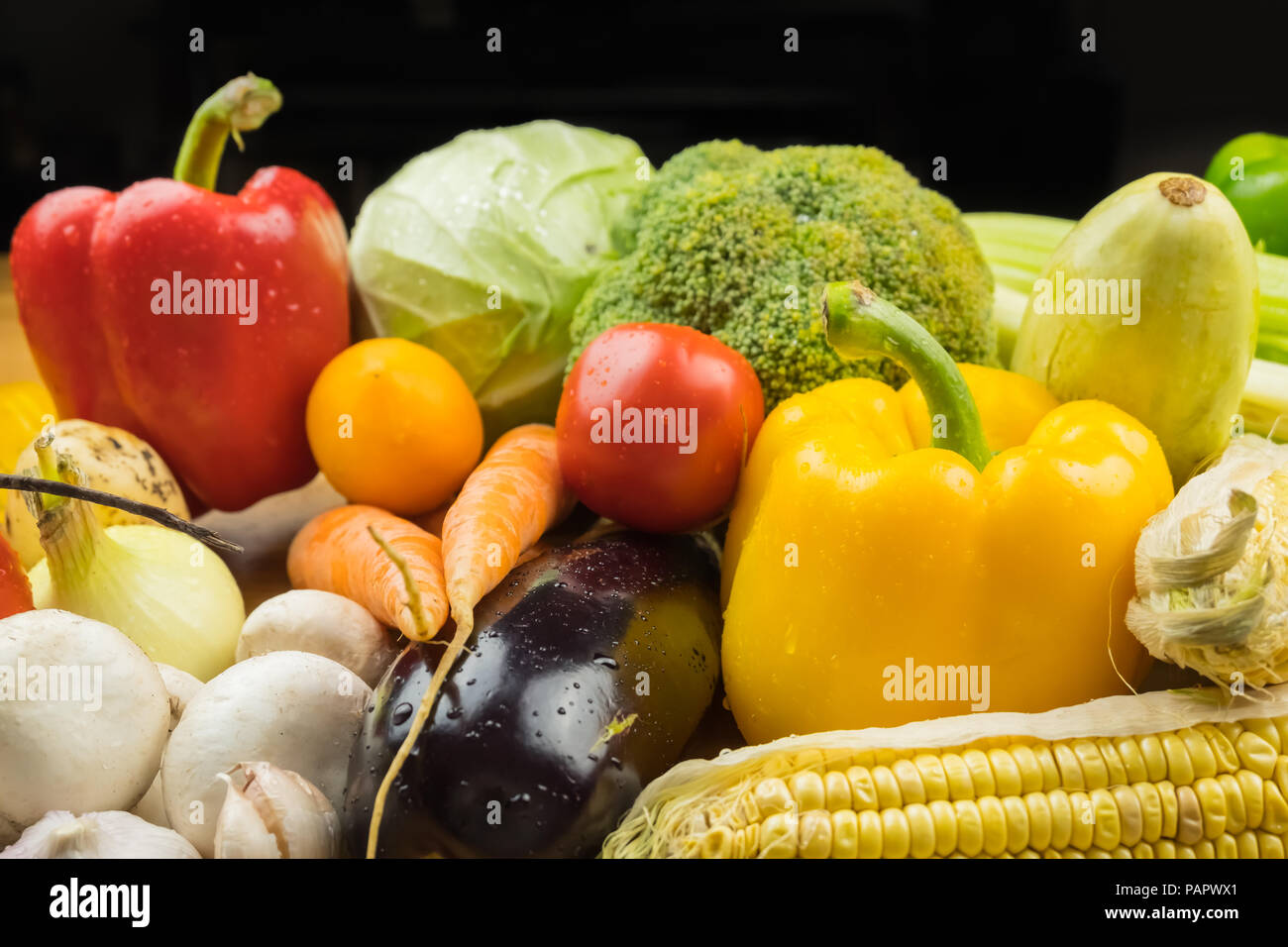 Close-up image of fresh organic vegetables. Locally grown bell pepper, corn, carrot, mushrooms and other natural vegan food. Stock Photo