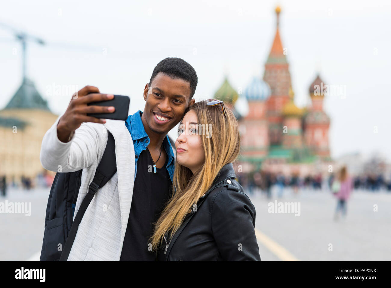 russia-moscow-couple-taking-a-selfie-and-smiling-PAPXNX.jpg