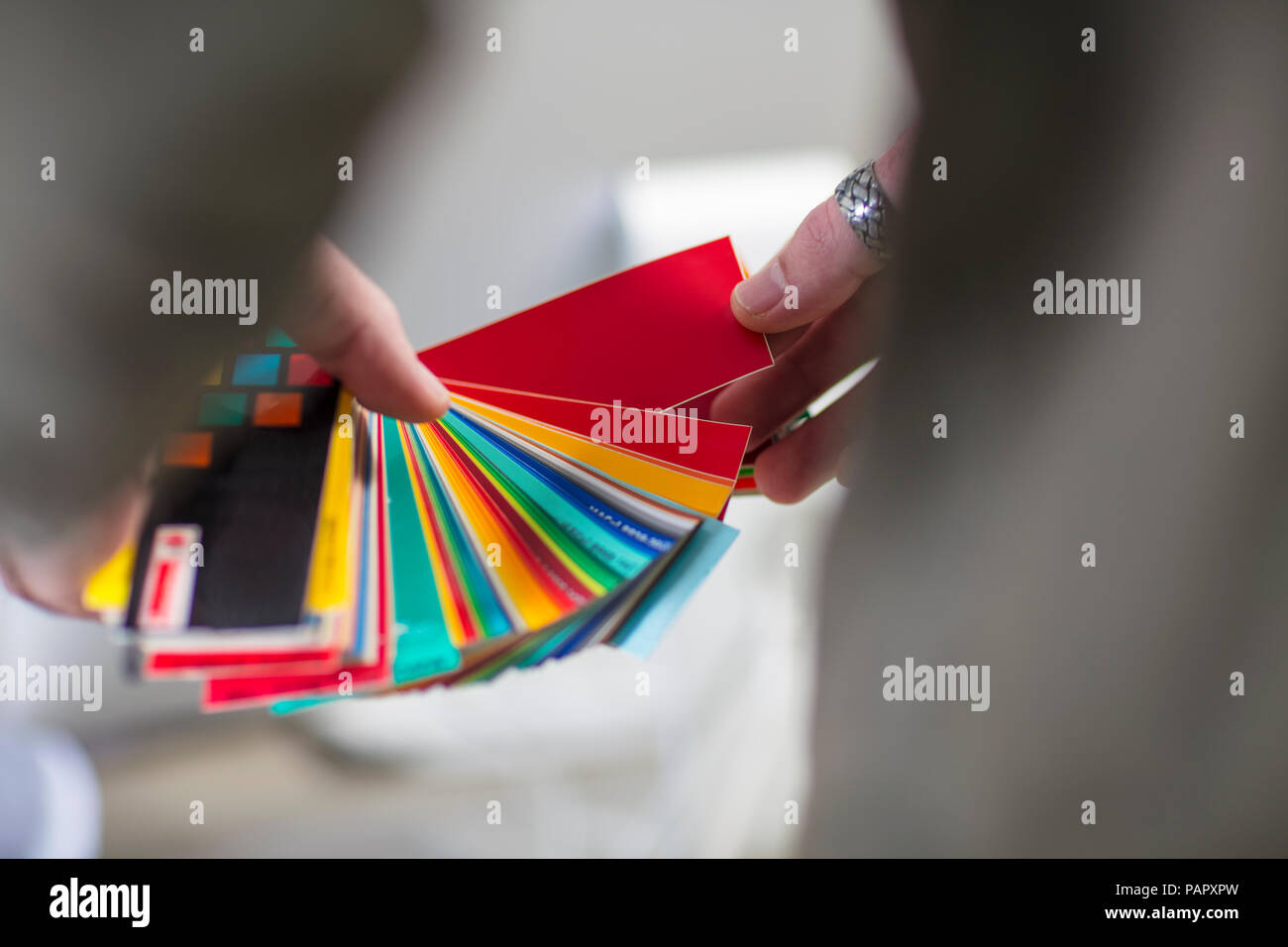 Close-up of man holding colour swatches in office Stock Photo