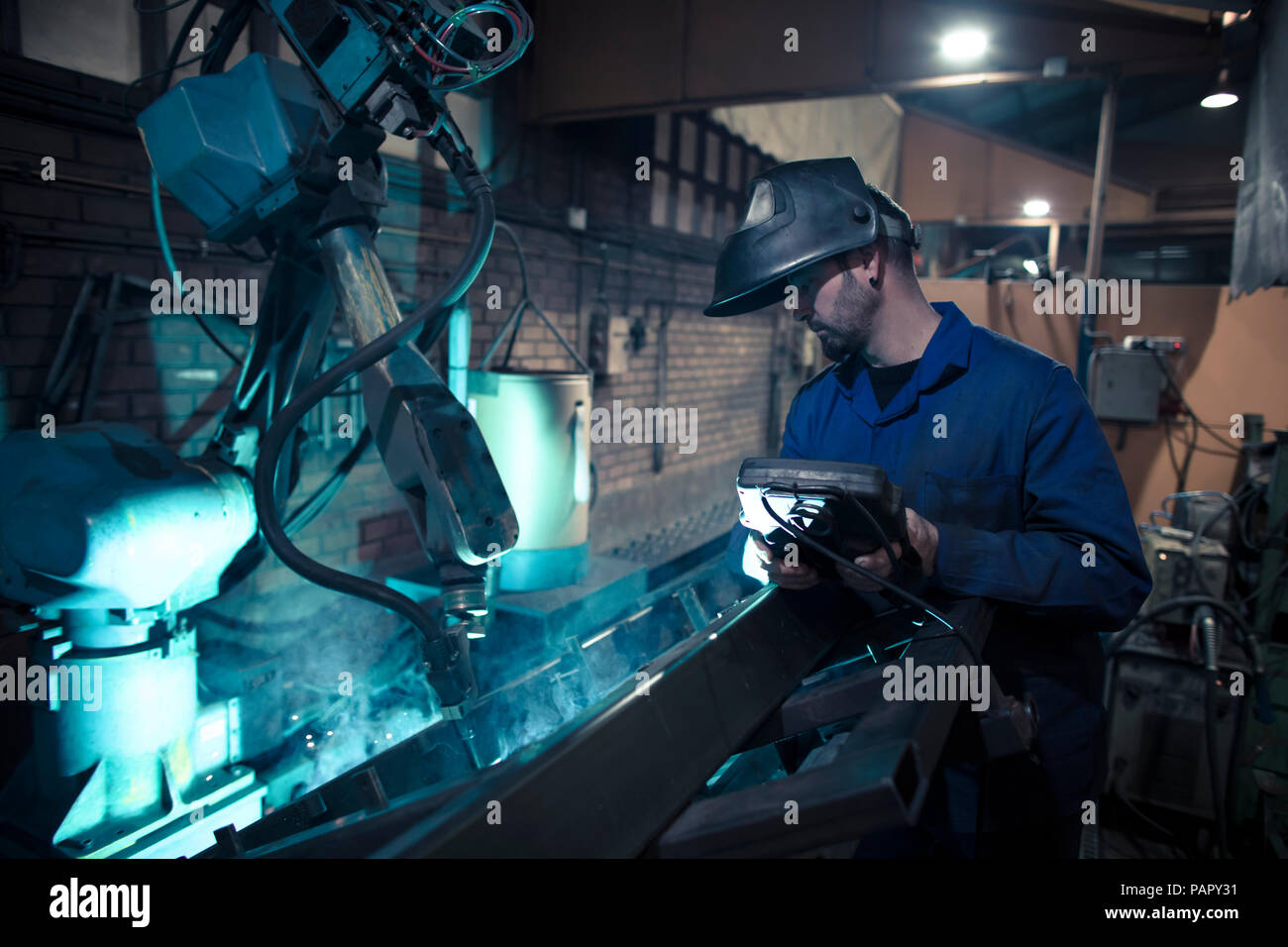 Welder welding metal with robot Stock Photo