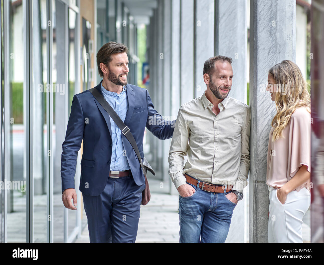 Business people talking outside office building Stock Photo